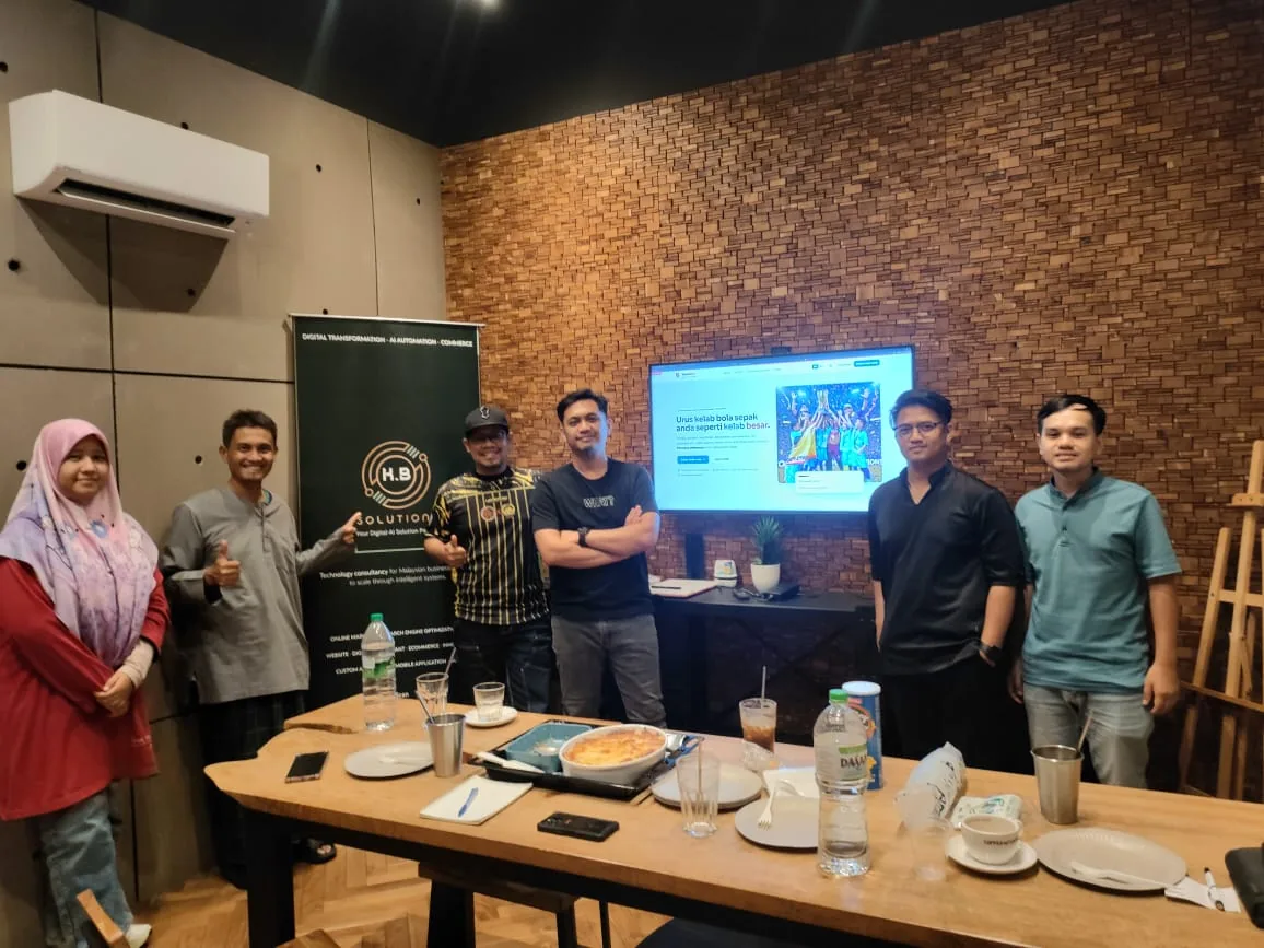 Keria Byte Solutions team with DMYS FC representatives in front of the TerasBola screen during a co-creation session